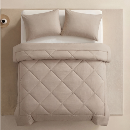 The 2-in-1 Comforter in Cream on a made bed