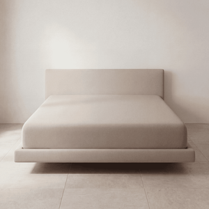 The Fitted Sheet in Cream on a mattress